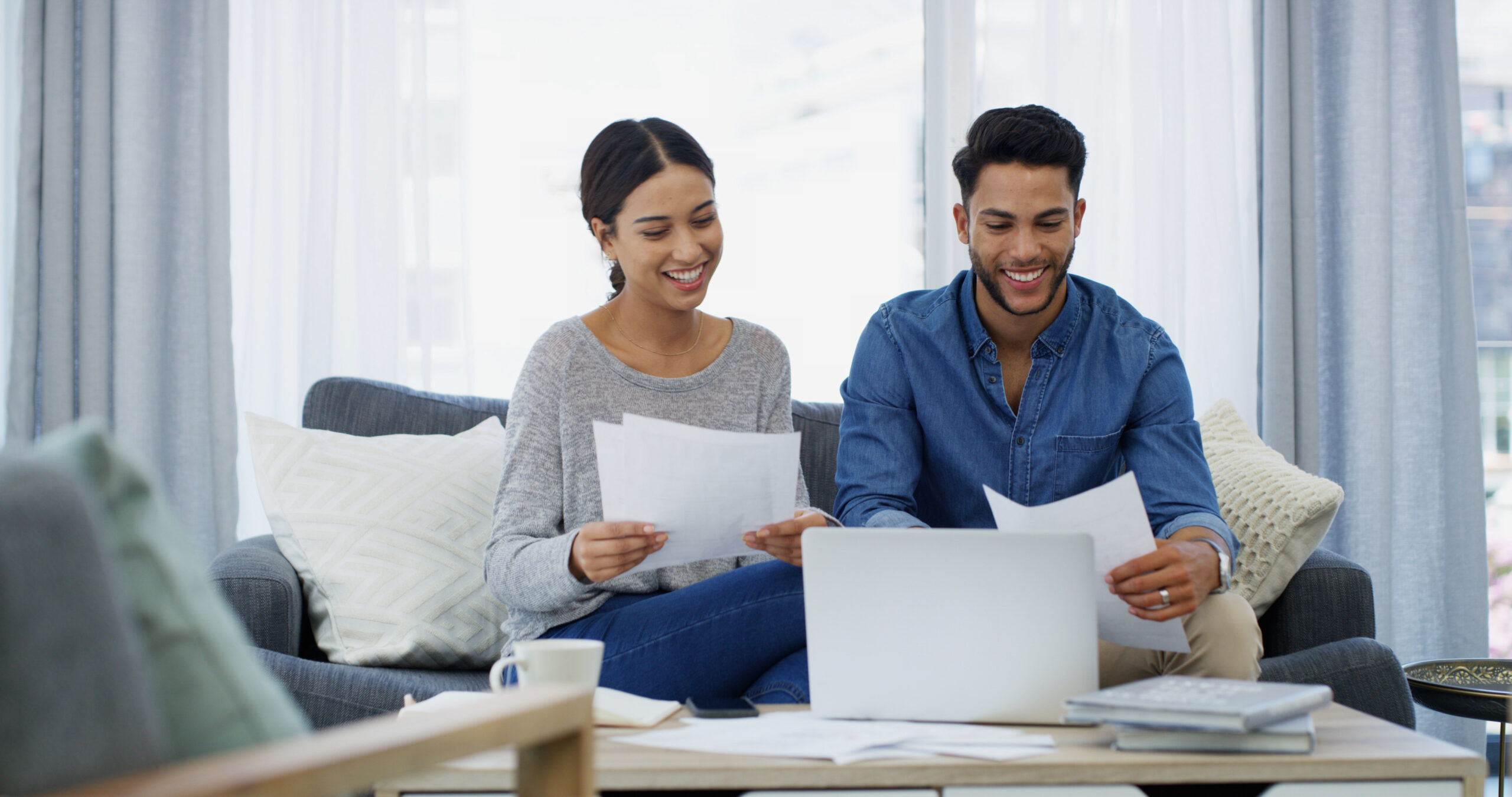 Smile, planning or couple with paperwork, laptop or salary budget for household bills or mortgage. Financial documents, credit score results or people with income for investment, report or savings.